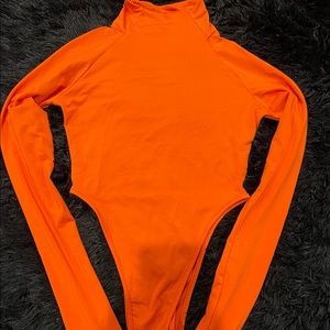 Orange spandex turtleneck bodysuit